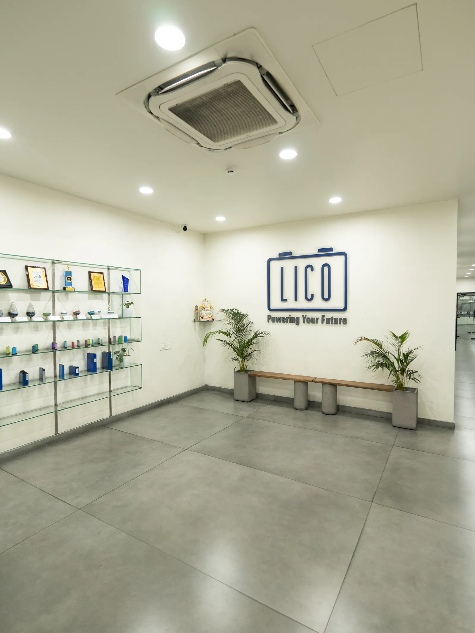 LICO office reception with branded wall and display shelves — LICO